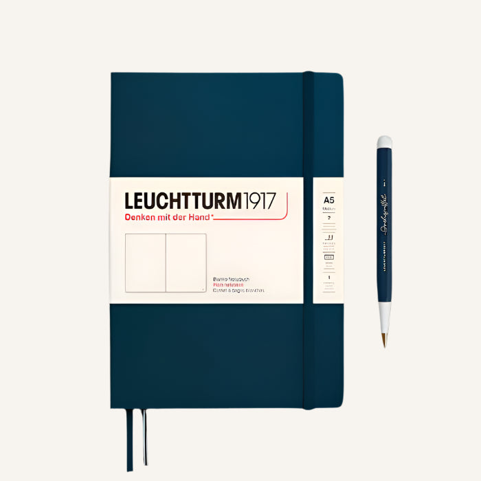 Blue notebook with a pen on a black background, featuring Leuchtturm1917 branding.