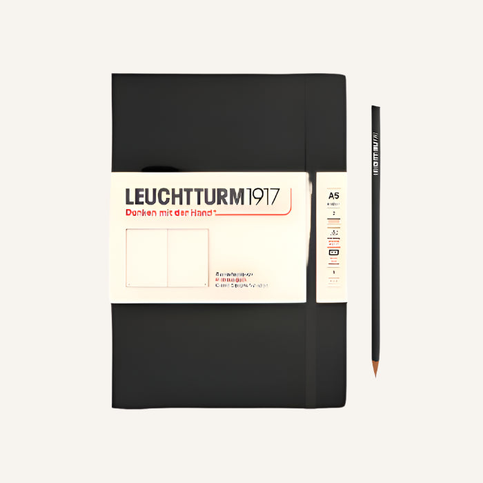 A black Leuchtturm1917 A5 notebook with a plain cover, a gusseted pocket, and two ribbon page markers. The notebook is numbered and has a blank table of contents.
