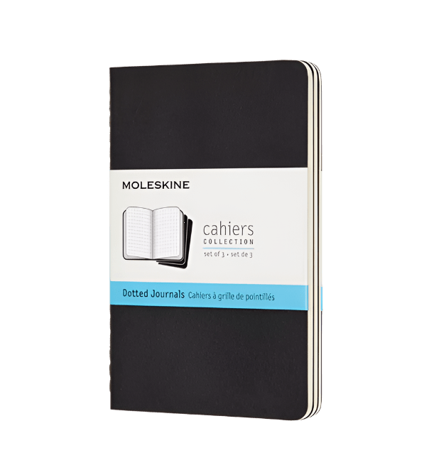 Black Moleskine notebook with dotted paper on a white background