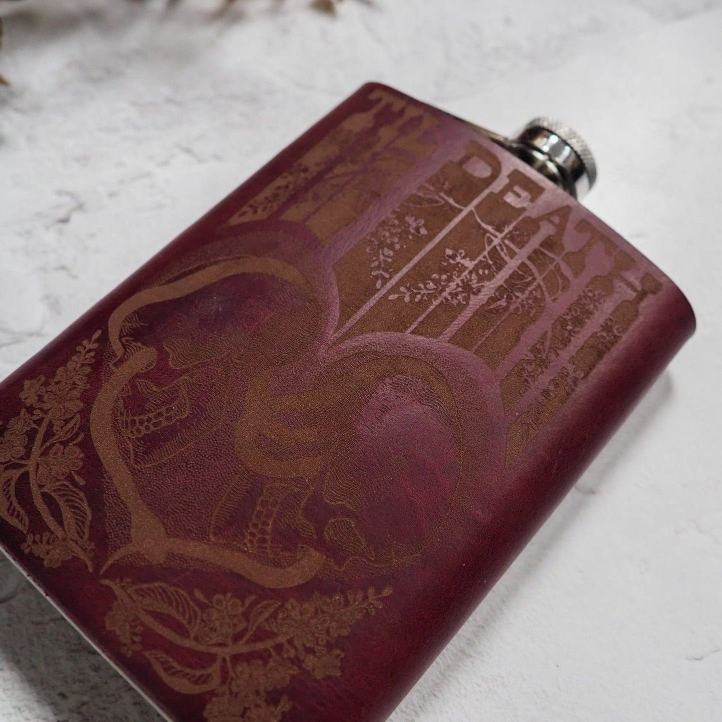 Handcrafted 8oz hip flask featuring a retro design of intertwined skulls for a unique wedding gift.