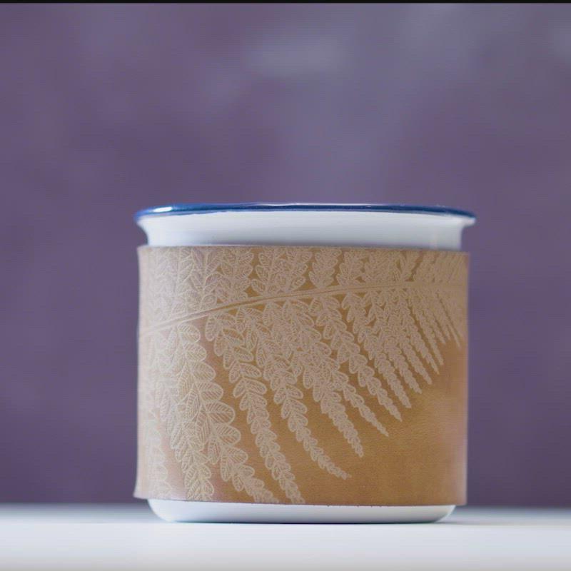 Video featuring a 360 view of camping enamel mug in fern leaf design at HÔRD.
