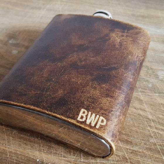 This Personalised Leather Hip Flask is handcrafted from luxurious British leather and bound onto a stainless steel flask.