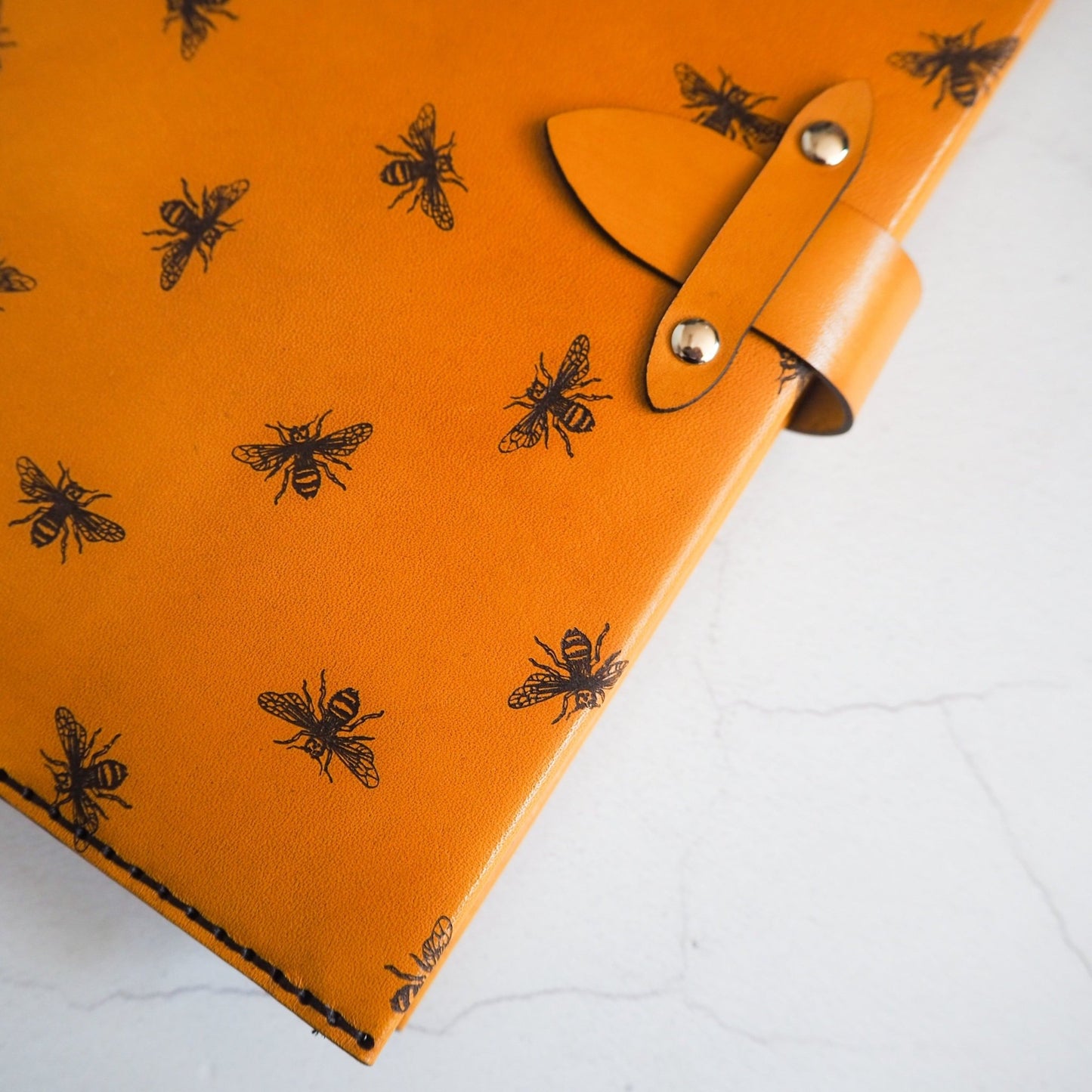 Clasp and bee engraving close-up on the Bee Journal with the clasp tightened.