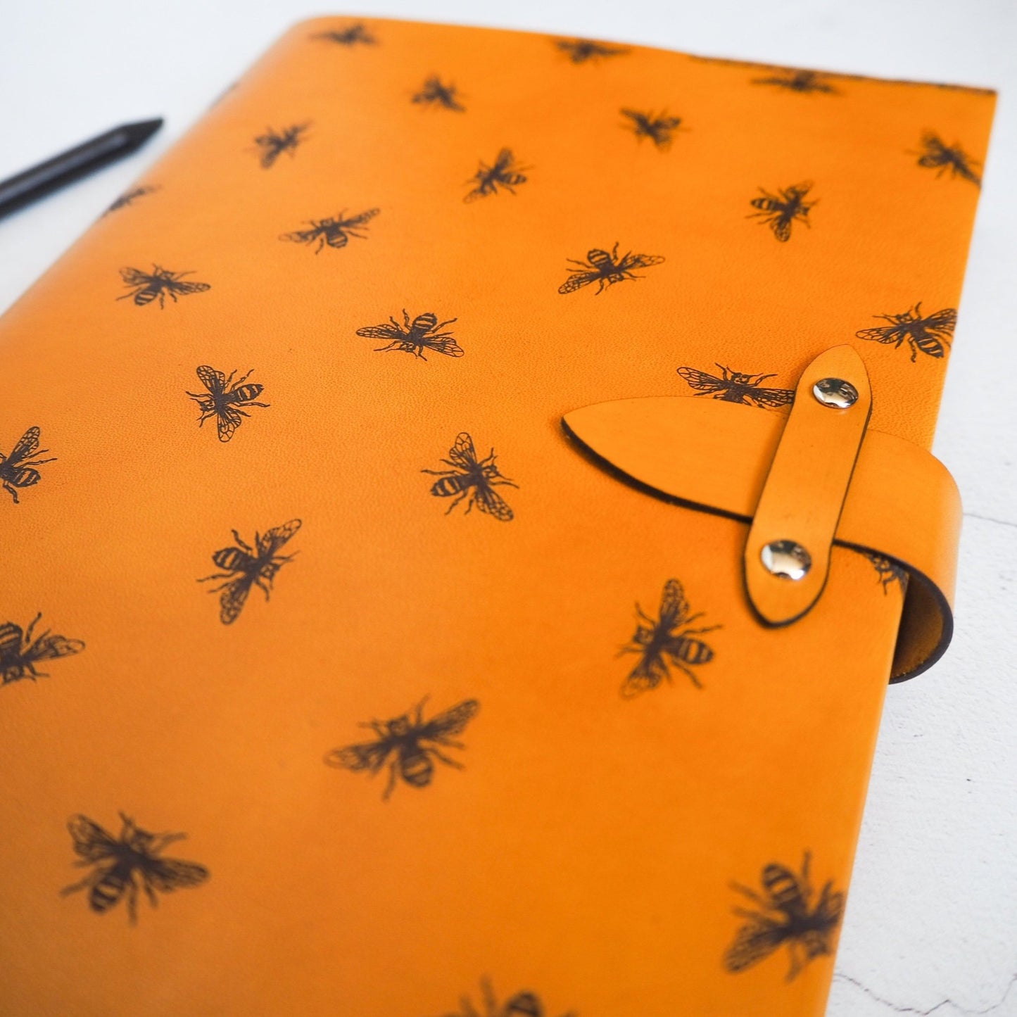 Close-up of the Bee Journal featuring engraving of bees.