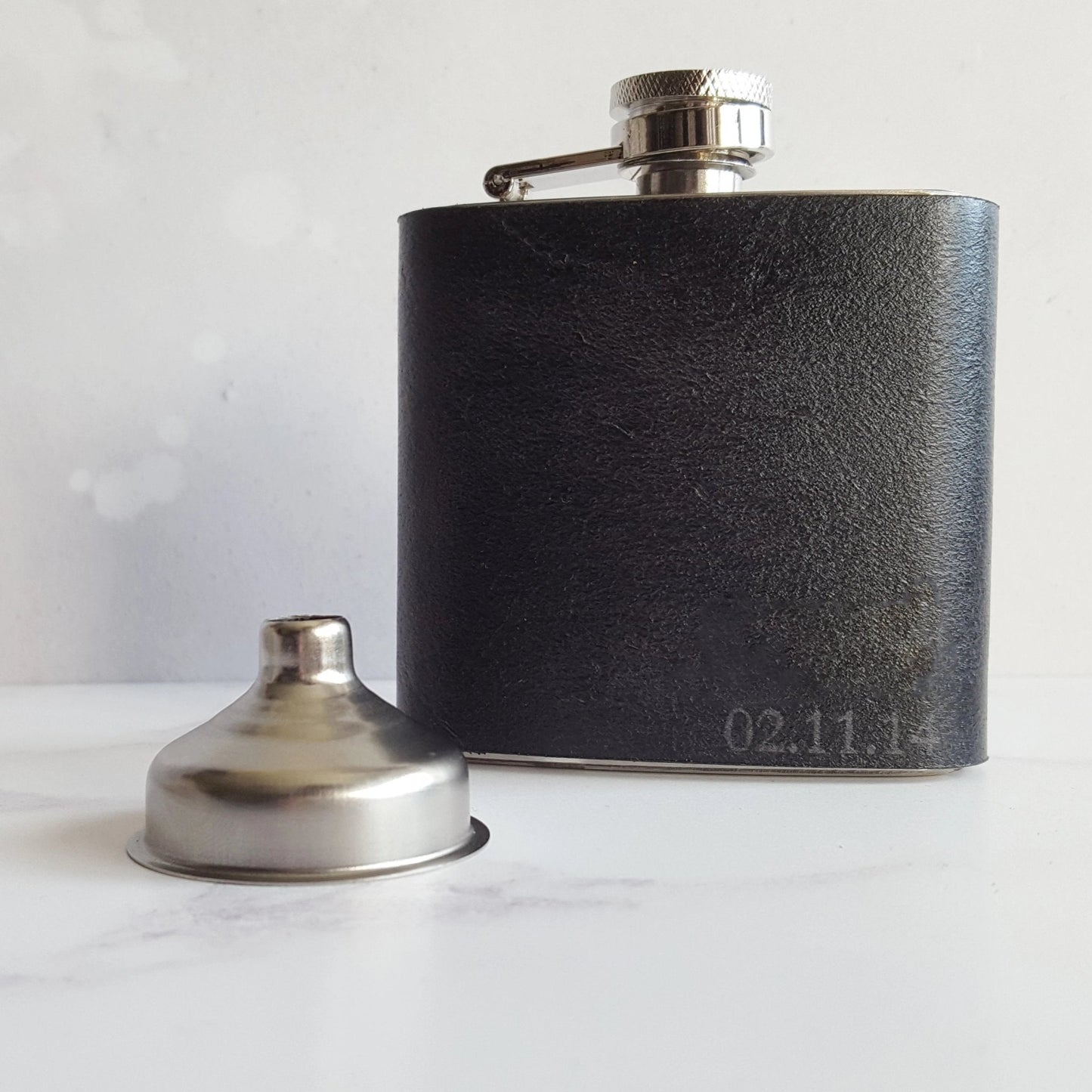 The black leather hip flask comes with a funnel to pour your favourote drink.