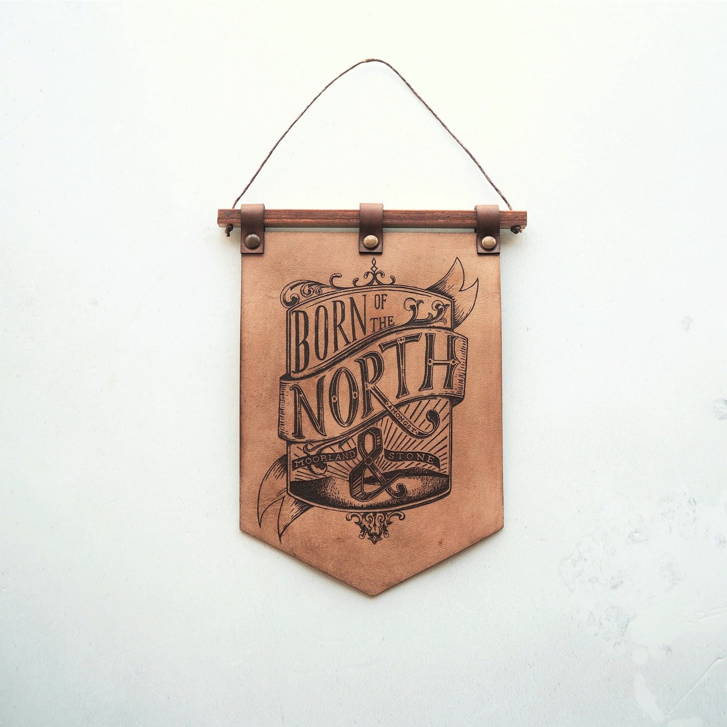 Full view of the Born of the North banner, crafted using luxurious leather for your home. A leather decoration from Hord.