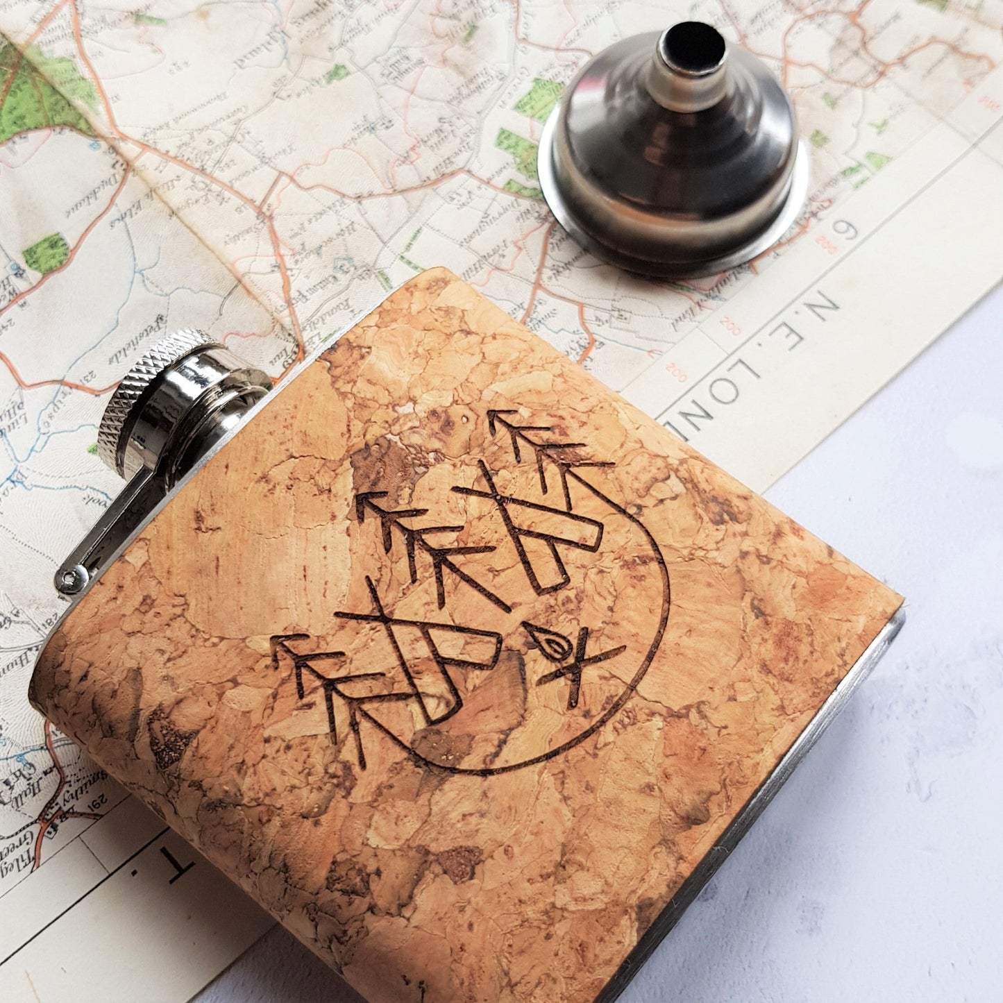 This contemporary hip flask is engraved with our signature campfire illustration.