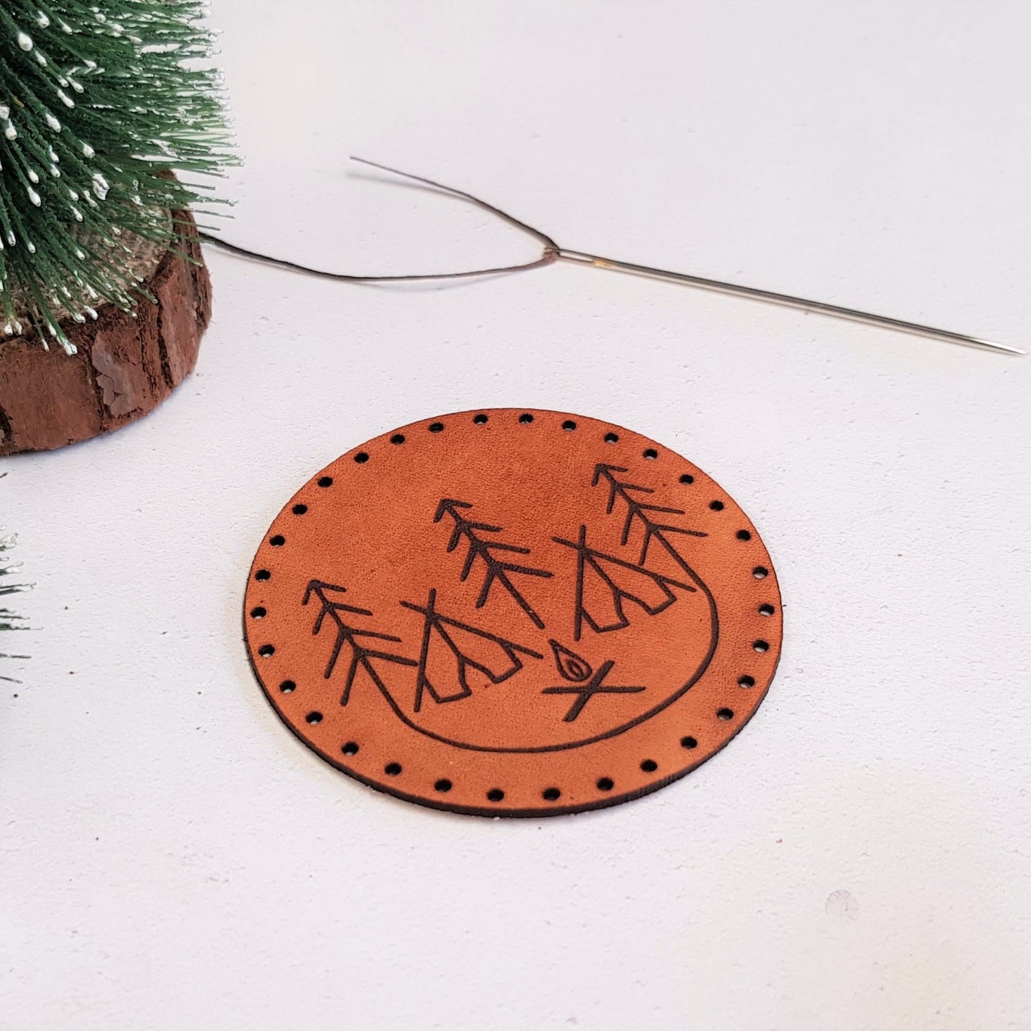 This campfire patch is crafted from luxurious leather and engraved with our campfire design.
