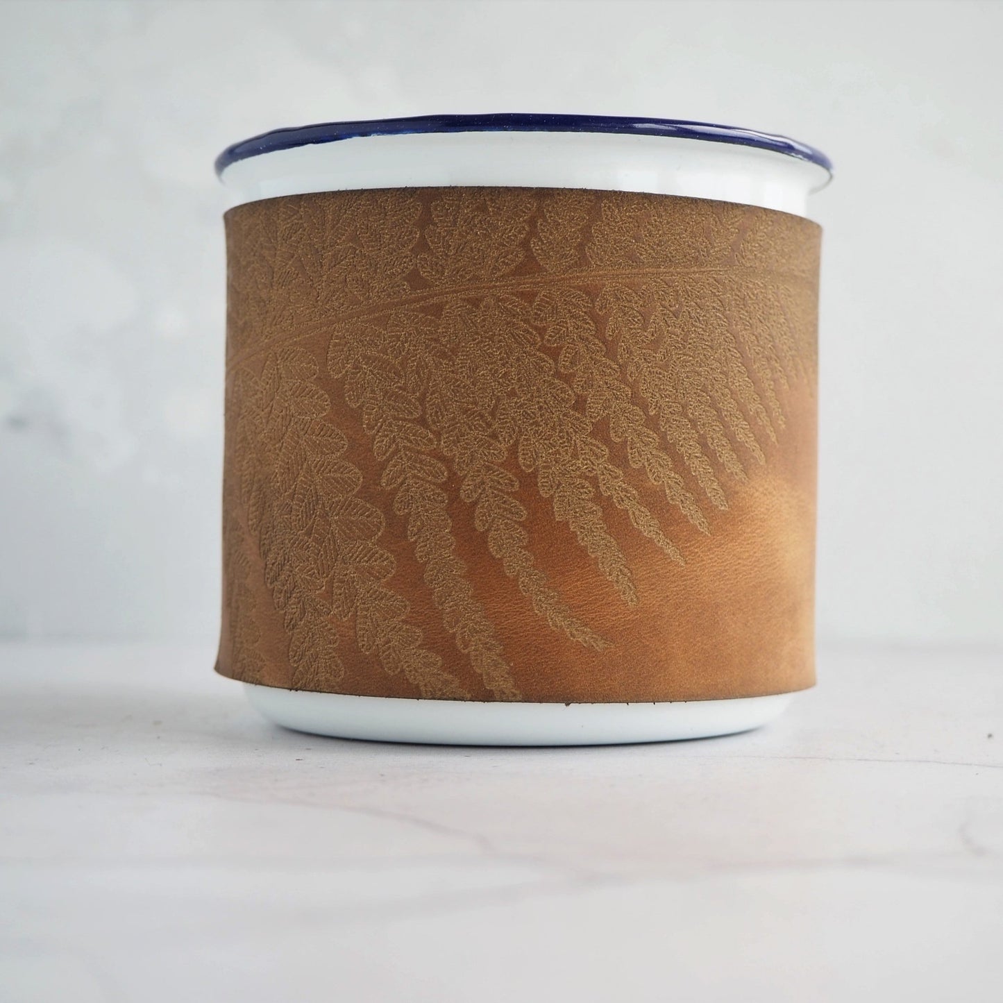 Fern leaves engraved onto the camping enamel mug by HÔRD.