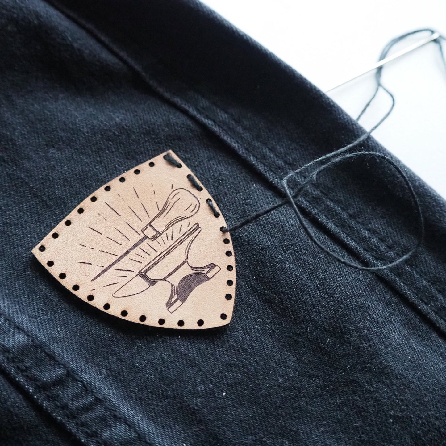 Craft Leather Patch, an art patch by HORD - This patch is hand dyed and engraved with our illustration of an anvil and awl, these patches are perfect stocking fillers for those who love to craft and make things by hand. Pre cut stitch holes make this wearable piece of art easy to sew.