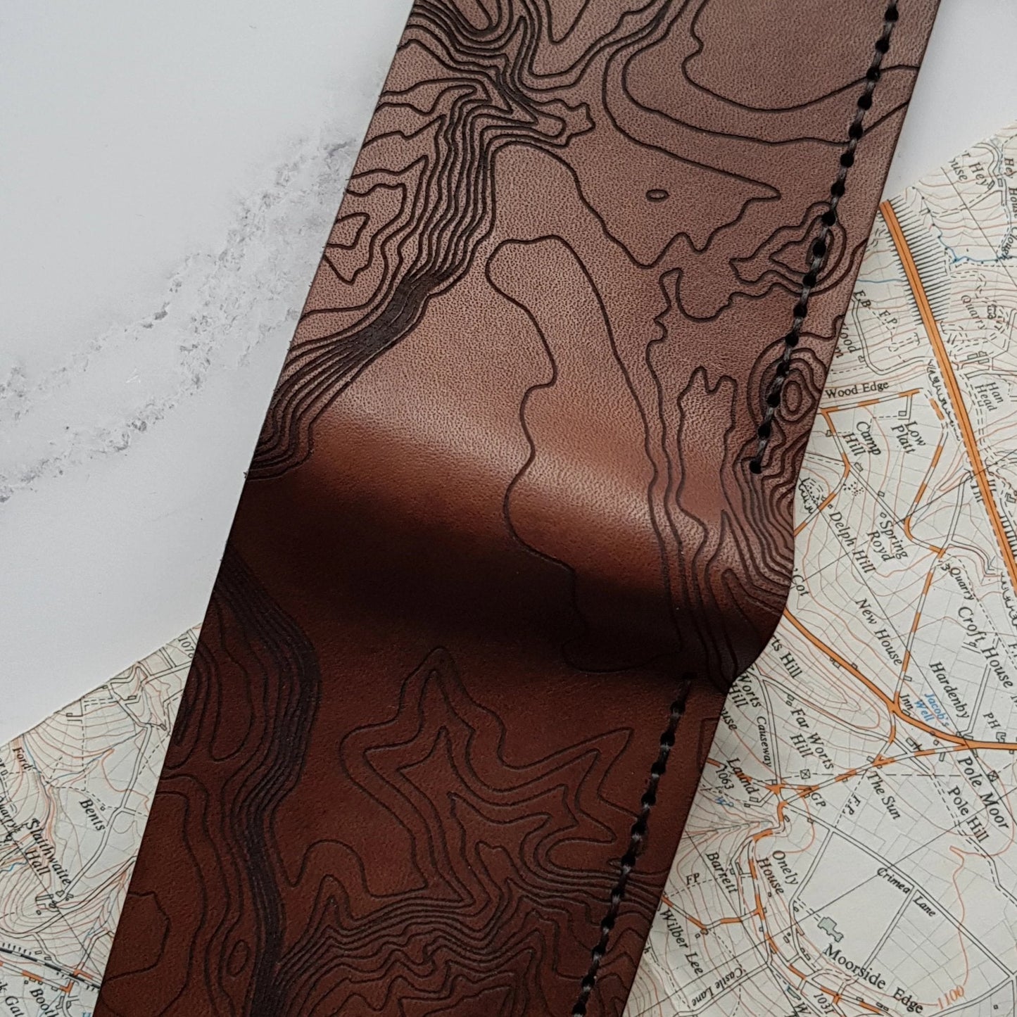 Closer look at the engraving of the topography of a Custom Topography Slim Mountain Wallet