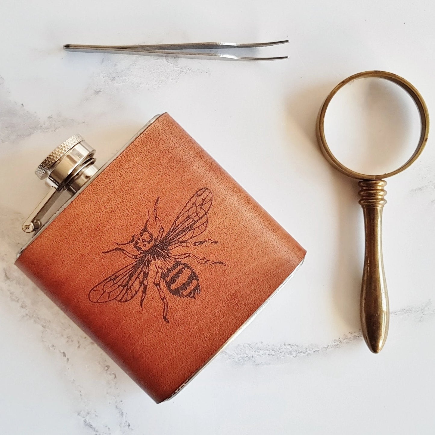This bee flask is made from luxurious leather that has been clad onto a stainless steel flask.