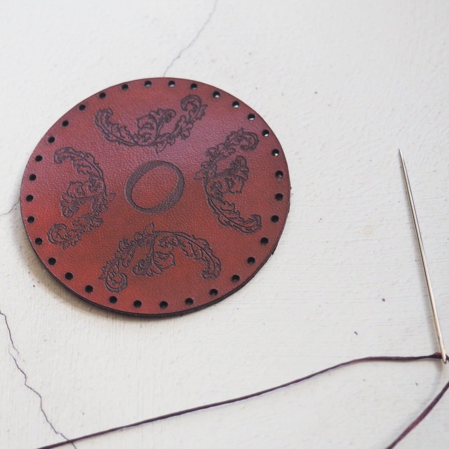 This design patch has been engraved with baroque leaved and a custom initial.