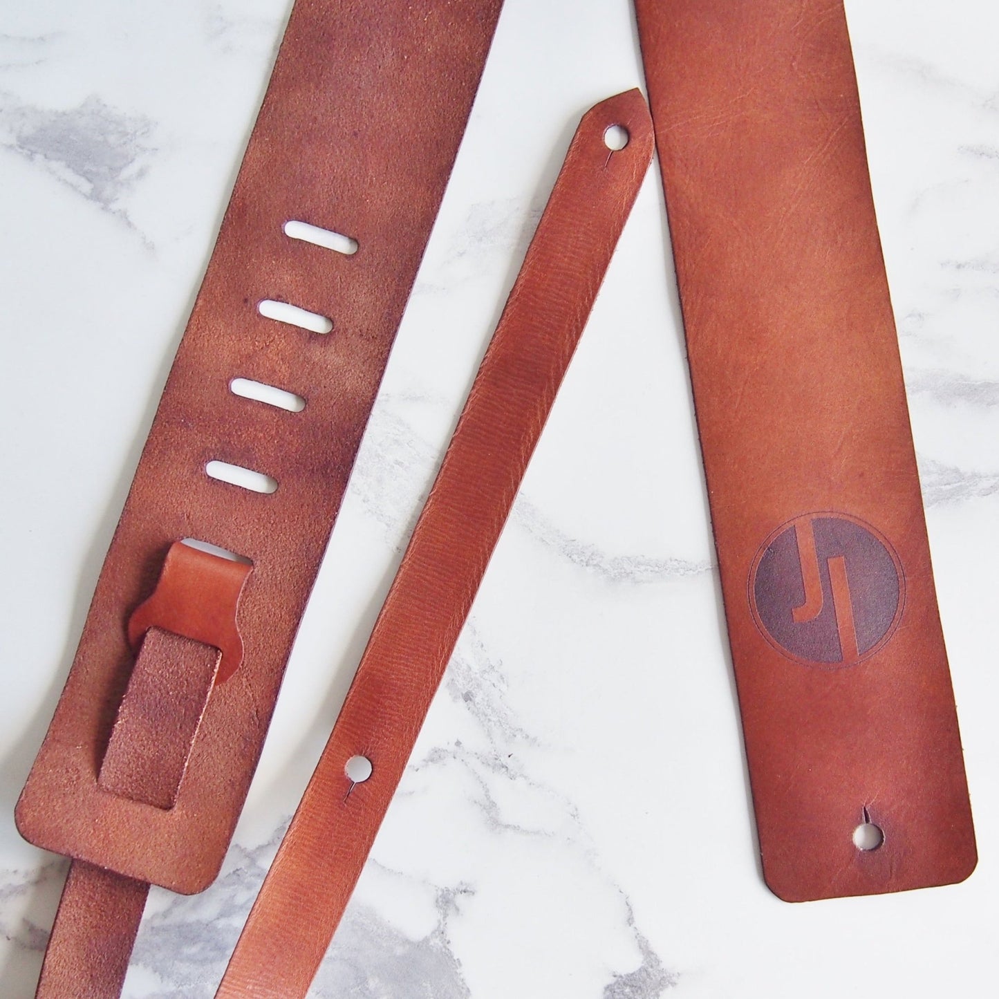 Custom Leather Guitar Strap With a Musician's Logo by HÔRD.