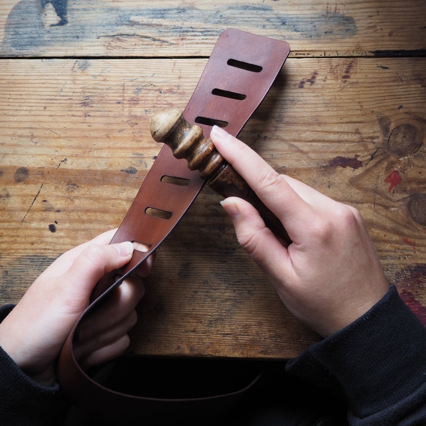 Personalised Leather Guitar Strap being treated for the perfect finish.