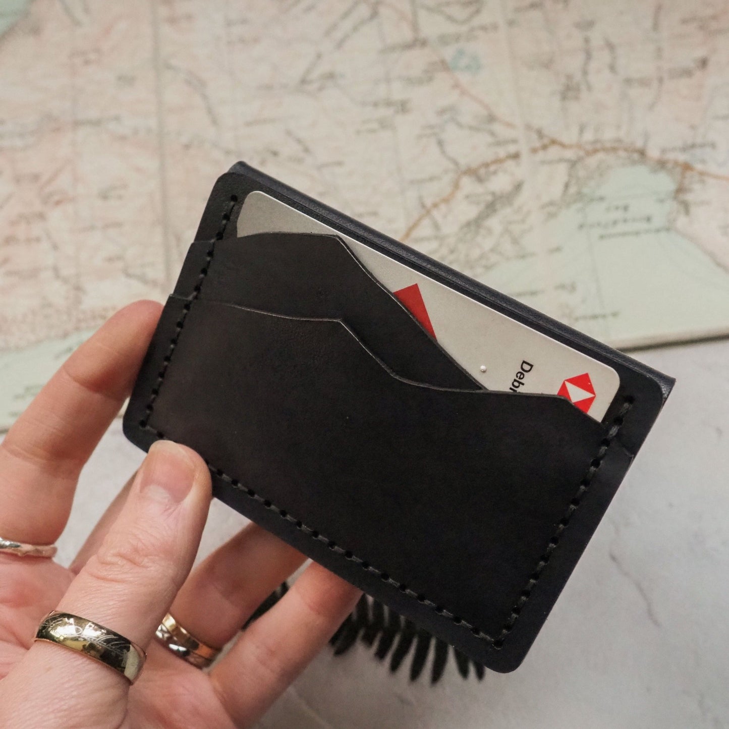 The card and money slot on the Minimalist Purse  featuring a card inserted onto the card slot.