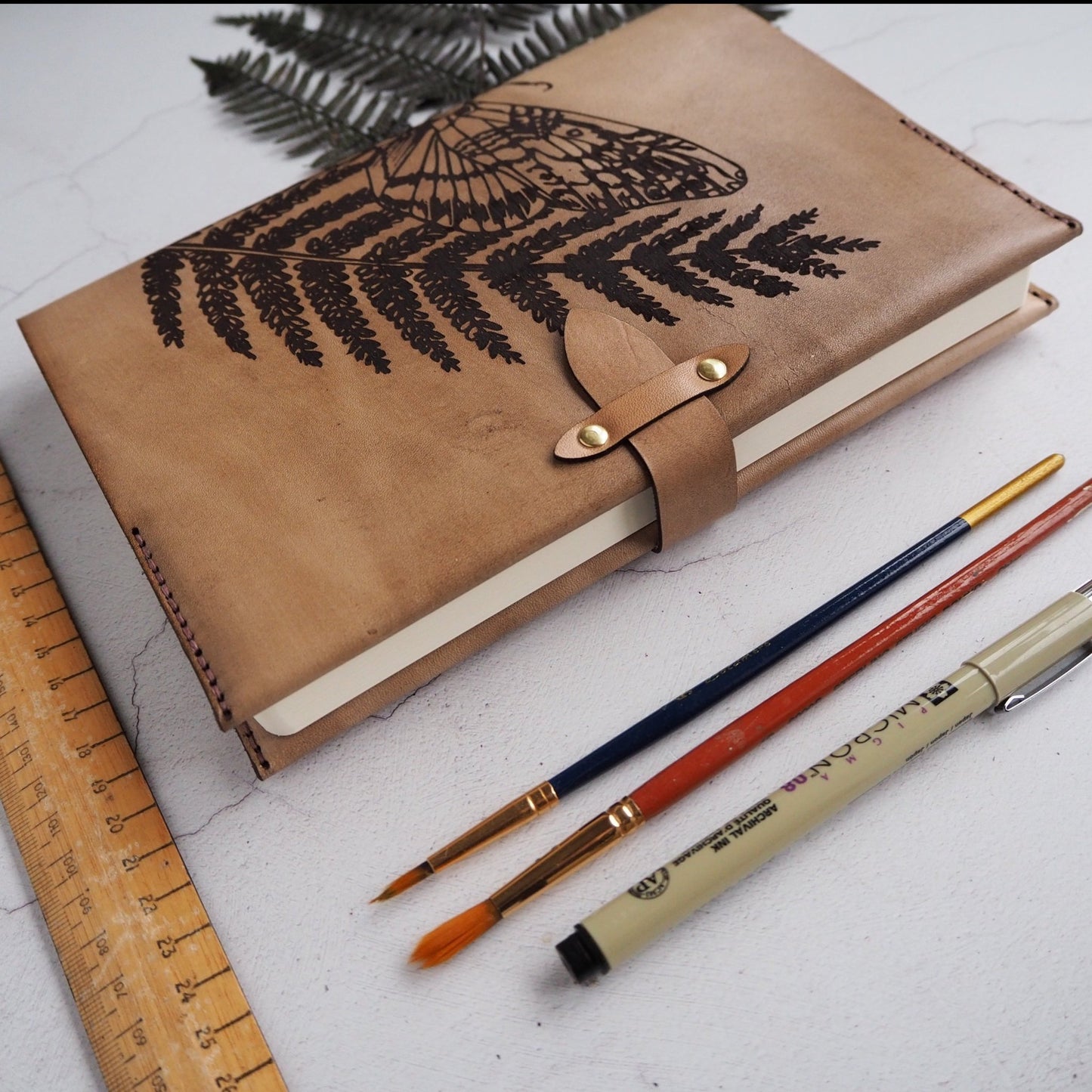Clasp tightened in the Moth Notebook, HÔRD's collection of leather covers for journals.