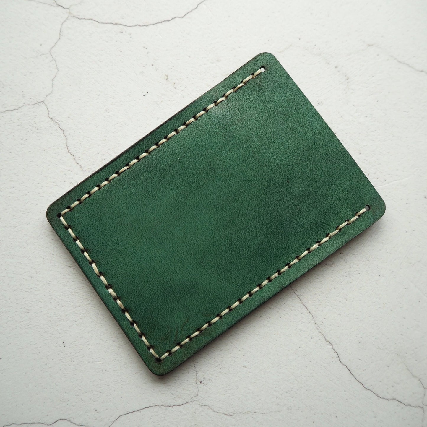 Back view of the Mountain Card Holder - Teal and Natural, a leather card holder personalised with a name or initial from Hord.