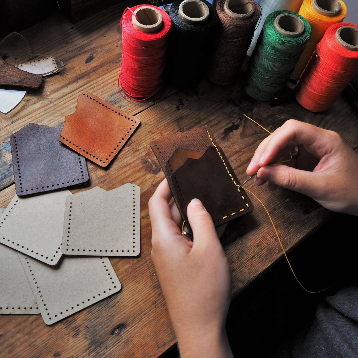 The Vertical Mountain Card Holder being hand stitched at our studio.