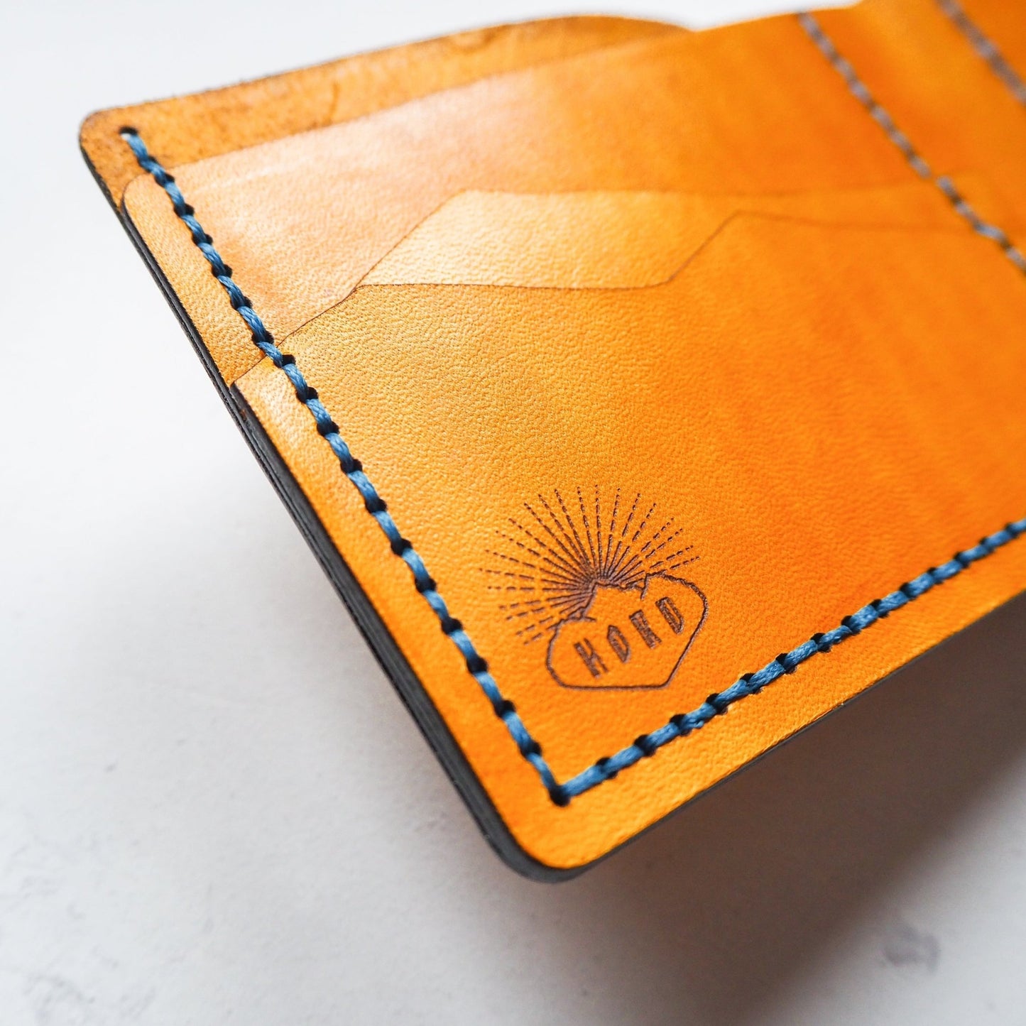 This Mountain Wallet with Clasp has been hand stitched in blue waxed linen thread.