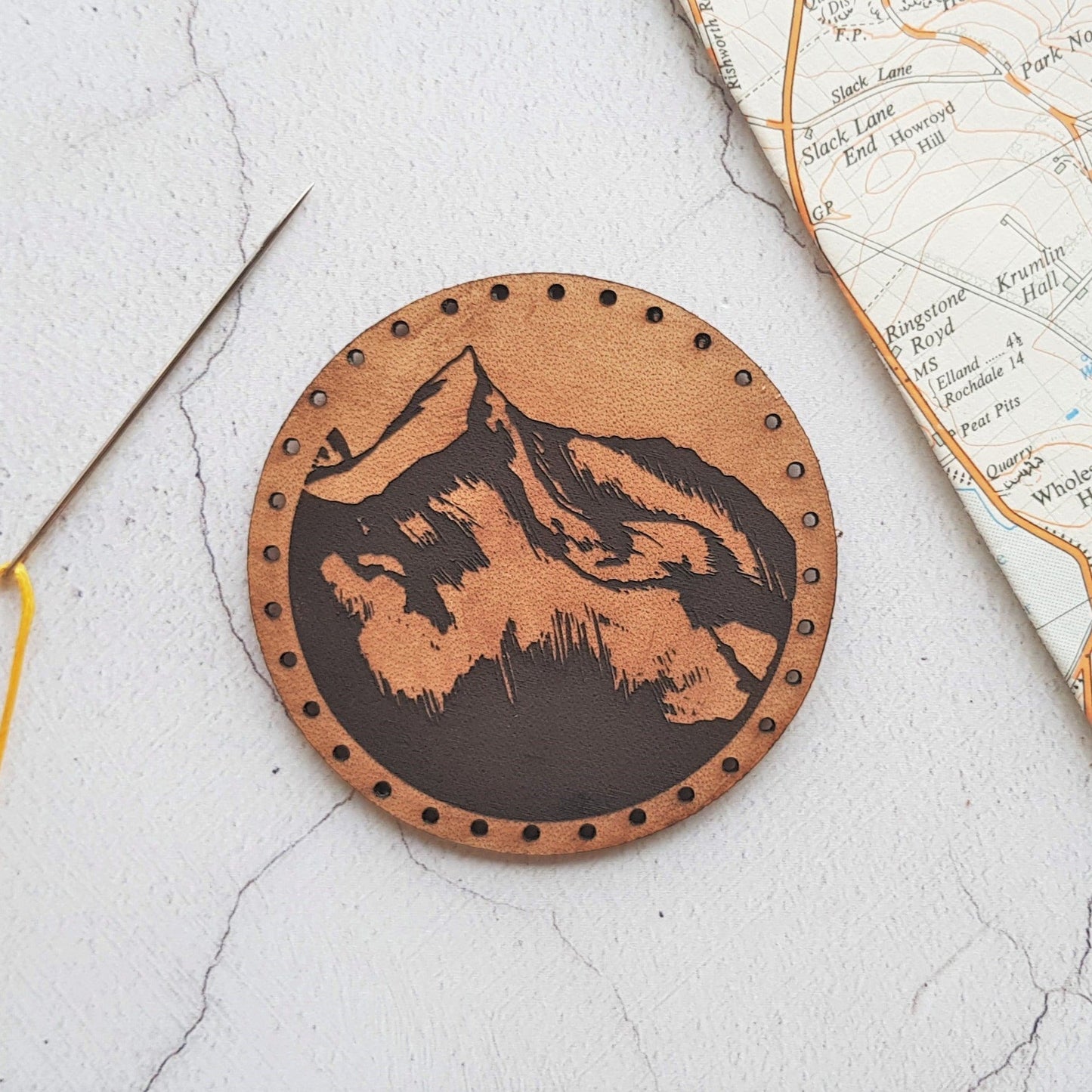 The mountaineer Patch by HORD - This leather patch is hand dyed and engraved with wonderful mountains. Perfect stocking fillers or gifts for lovers of the outdoors, mountaineering and hiking.