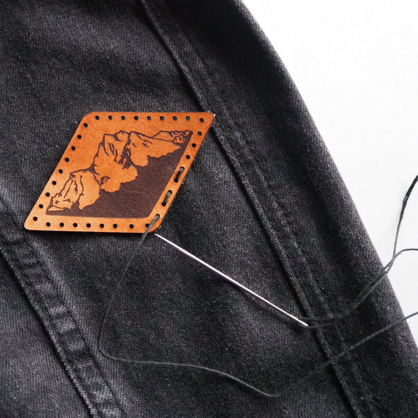 This mountain patch comes with pre cut stitch holes make it easy to sew onto your desired item.