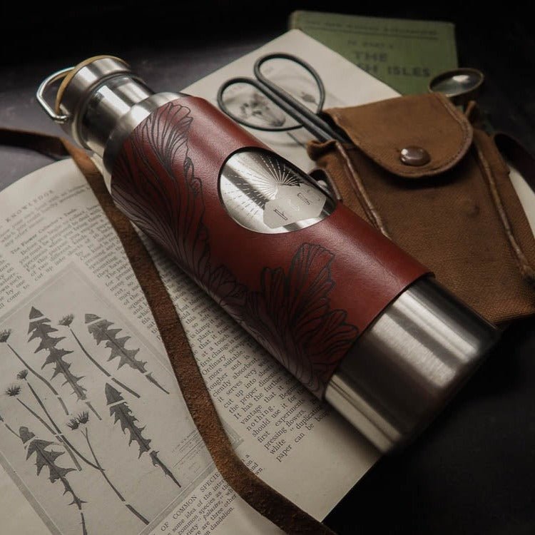 Mushroom Water Bottle - Stainless Steel 600ml. The leather wrap is engraved with a detailed illustration that explores the paterns of the frills of the splitgill mushroom. The leather wrap is dyed in burgundy. by Hord.
