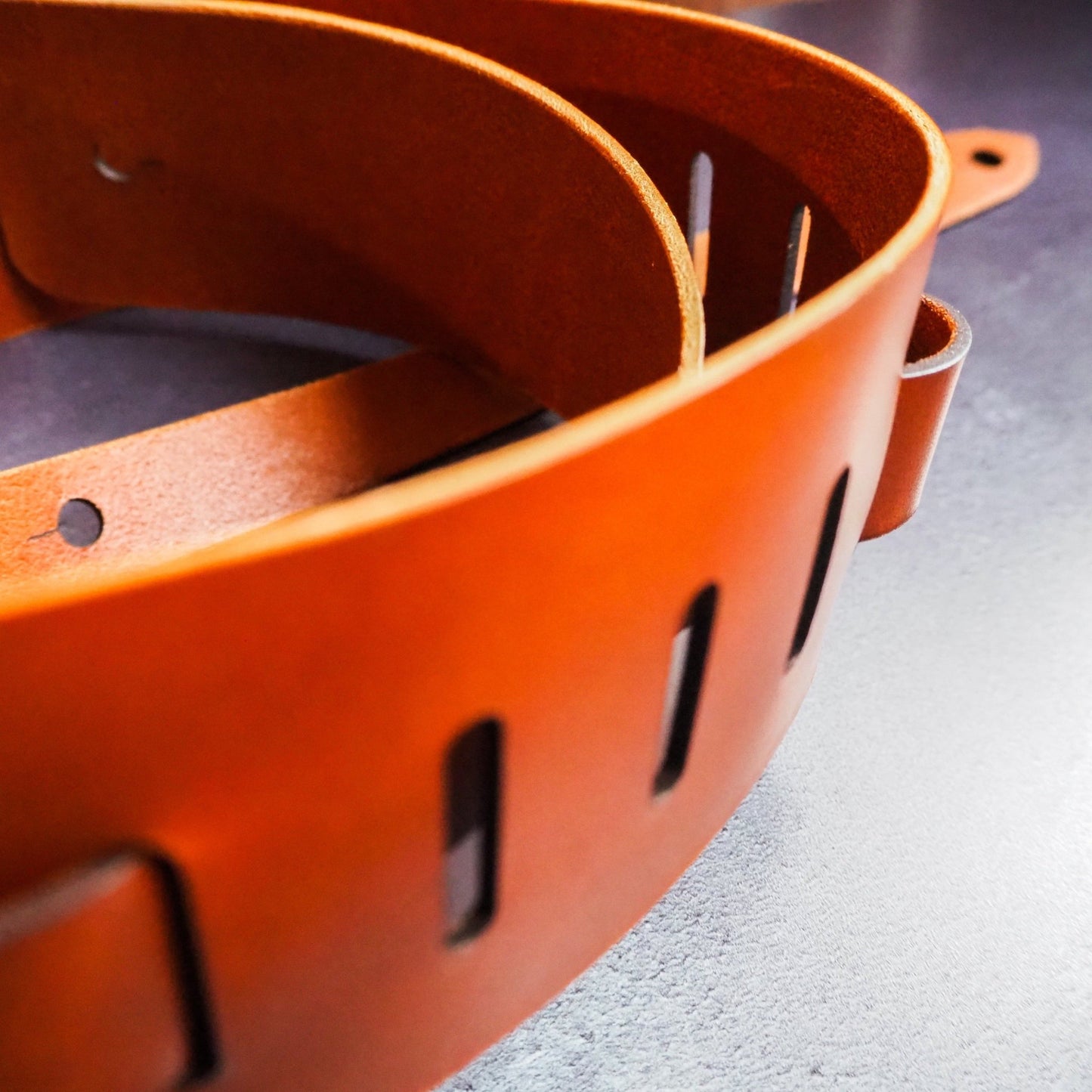 Adjustable holes on the Personalised Thick Leather Guitar Strap in Tan by HÔRD.