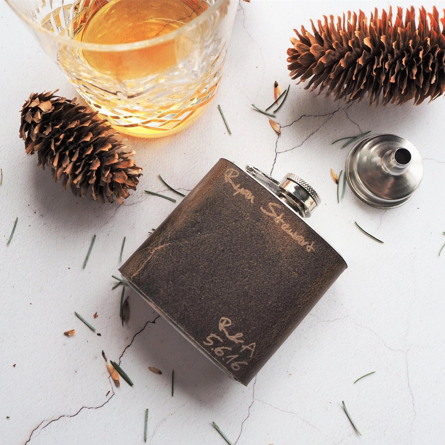 This personalised wedding hip flask has been handcrafted using luxurious leather and is engraved with your name, initials, and date.