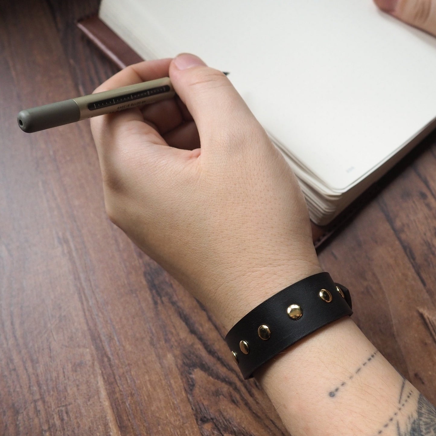 This studded cuff comes in range of leather colours to match your style.