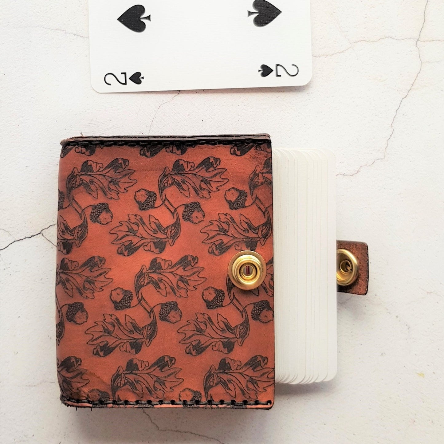 The Acorn Playing Card Holder with a full deck of cards inside.