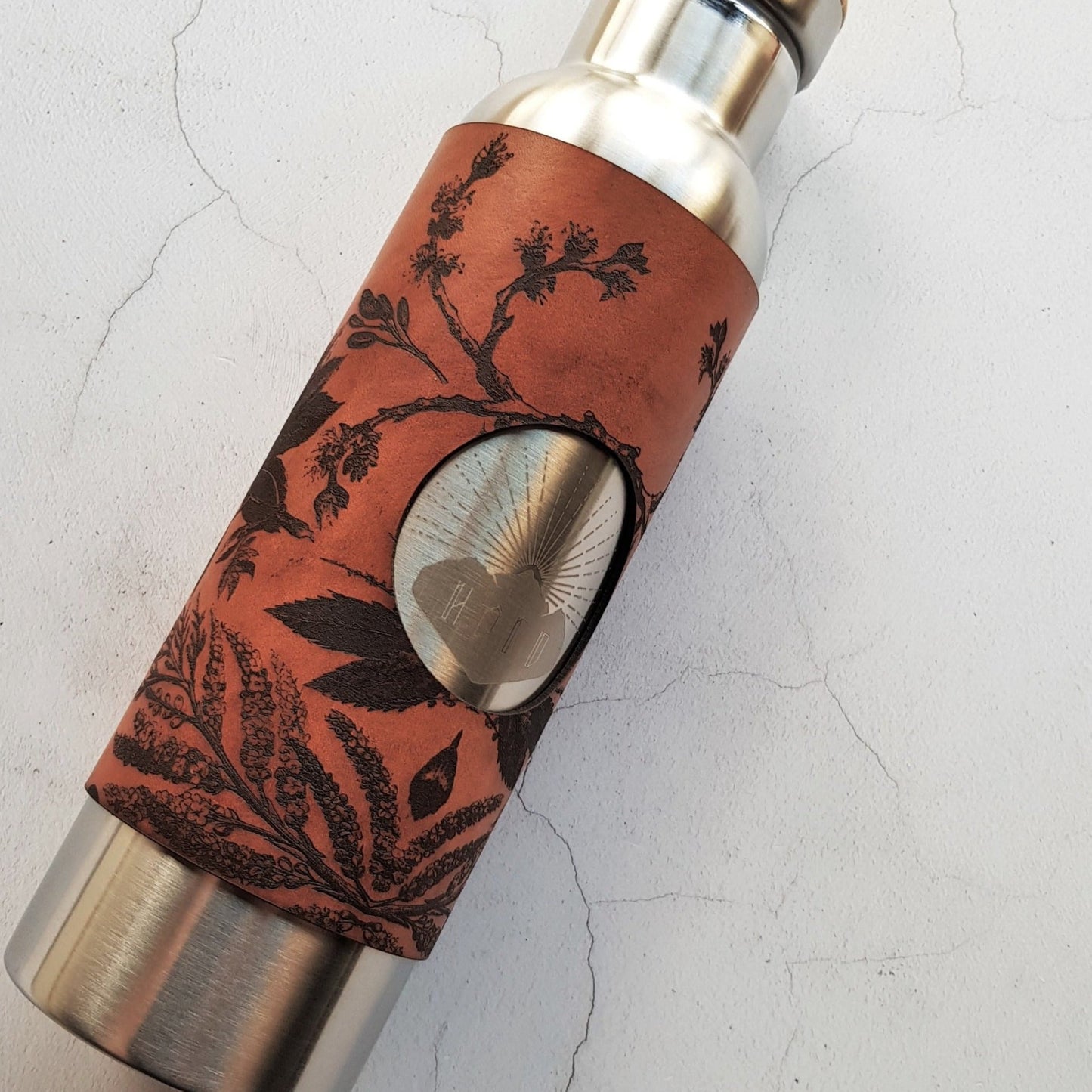 This ice skating water bottle is engraved with the illustration of botanical designs.