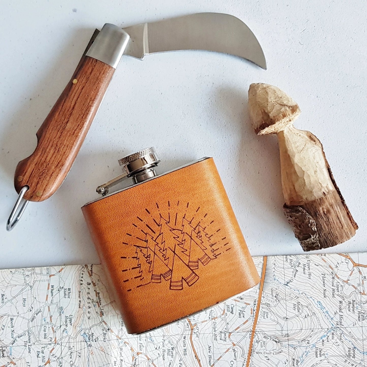 This camping flask comes engraved with an illustration of the woods.