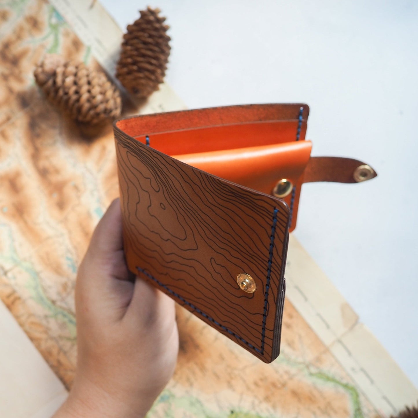 This personalised wallet with coin pocket has been hand stitched with blue waxed linen thread.
