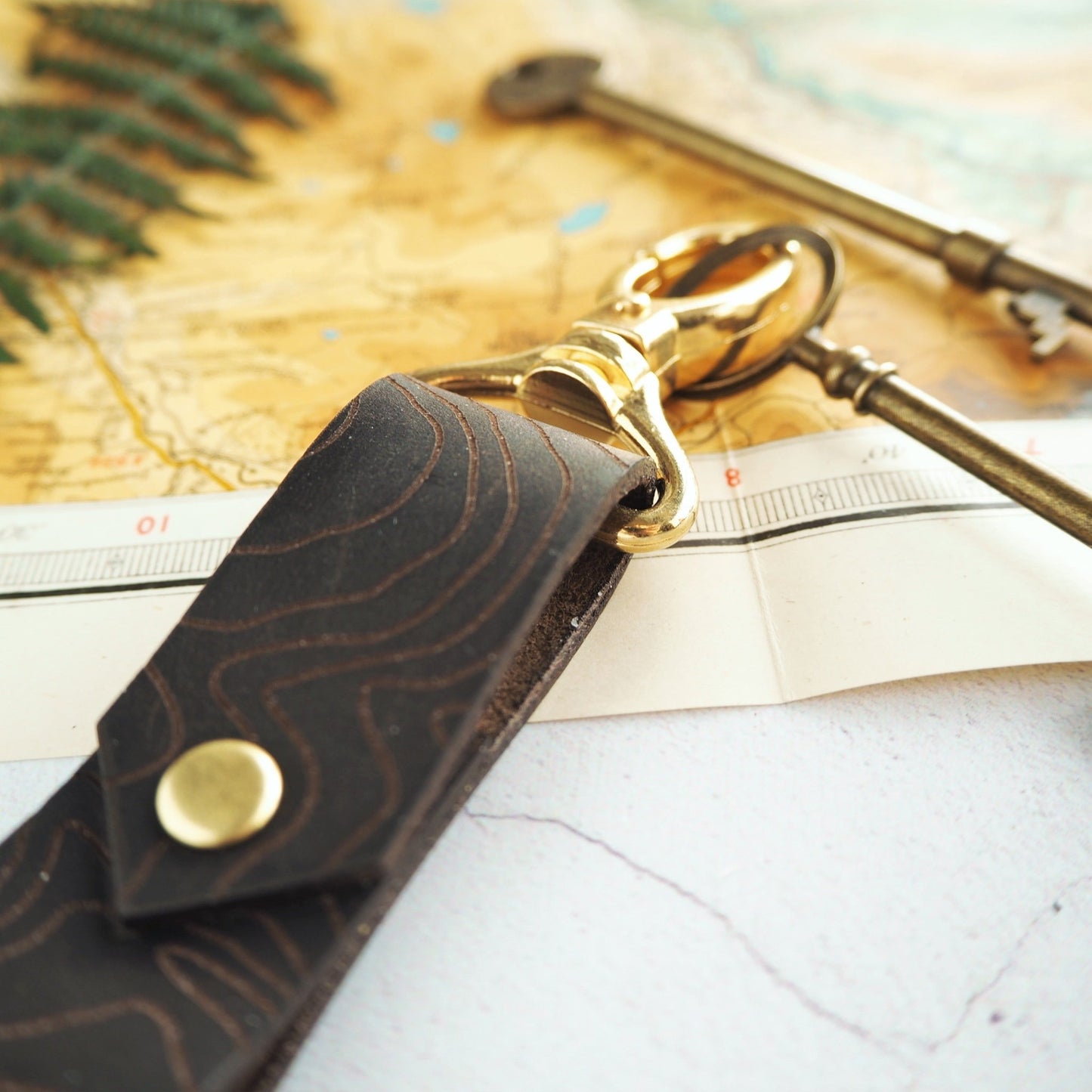 A custom place engraved onto a sturdy leather with a brass swivel.