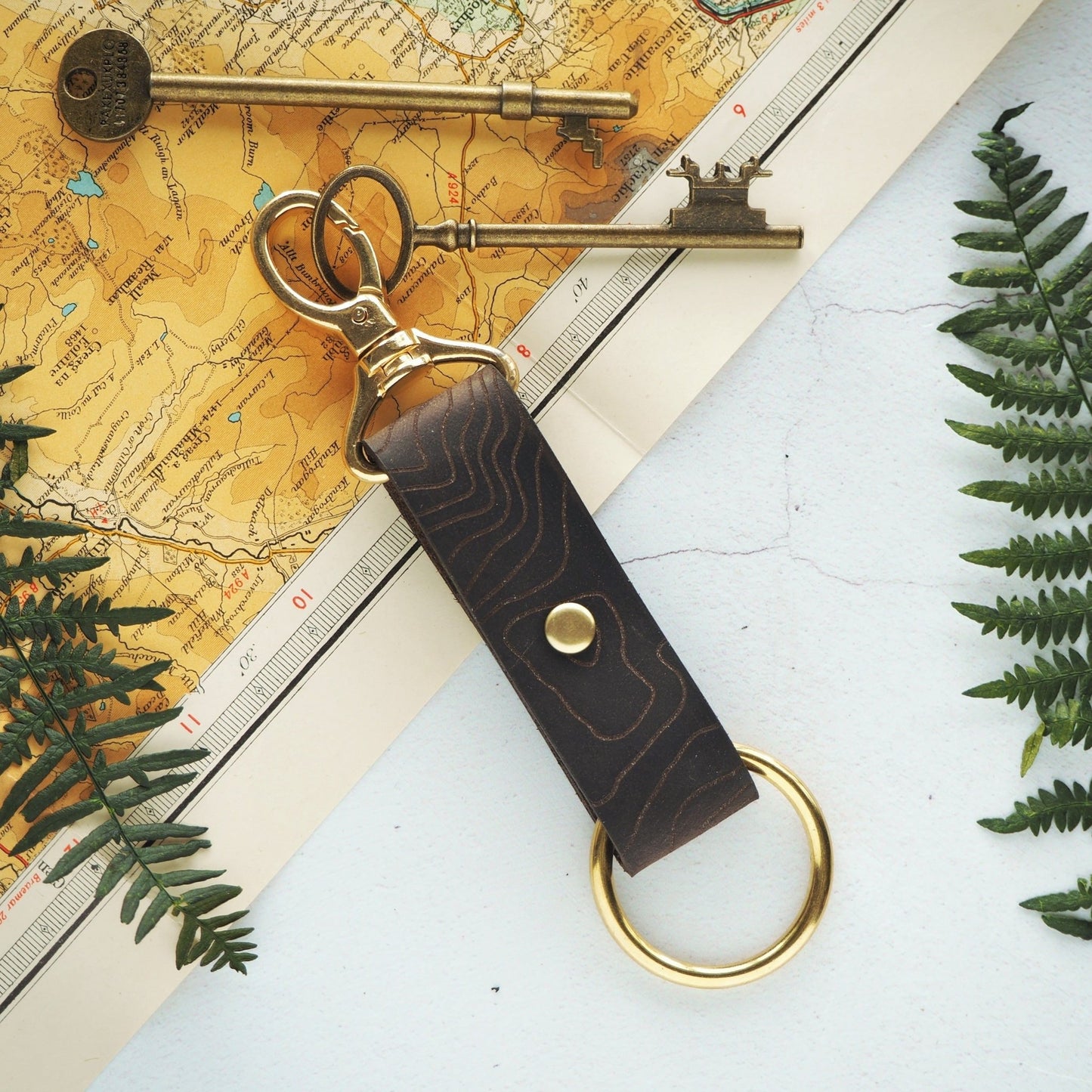 A camper keyring featuring a custom place engraved along with brass swivel clip and O-ring.