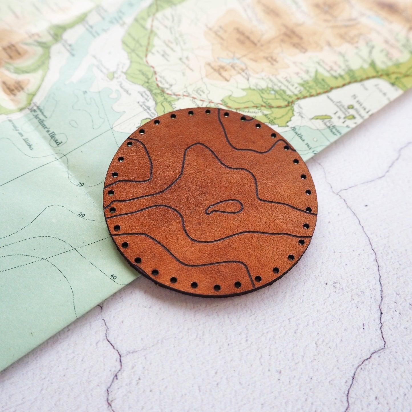 A leather patch which shows part of your topographic location.
