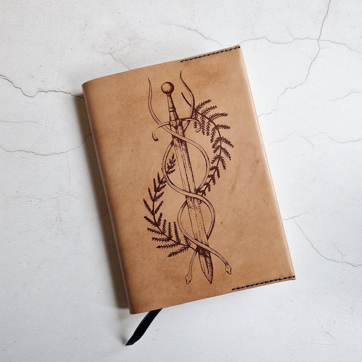 The Dagger Journal by Hôrd featuring a dagger and two snakes coiled around it.
