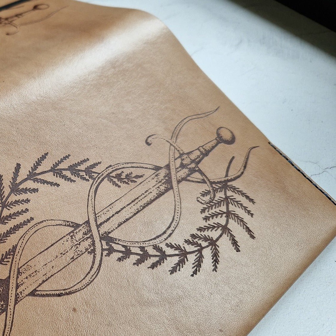 Close-up of the Dagger Journal showing the engraved design.