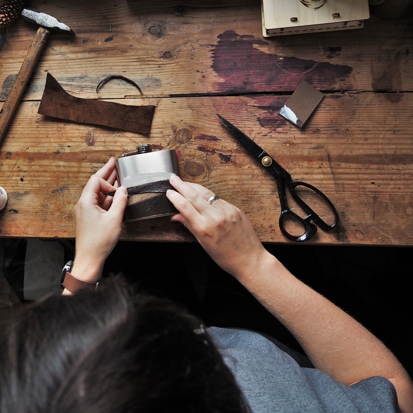 The leather hunting flask being handcrafted at our studio.