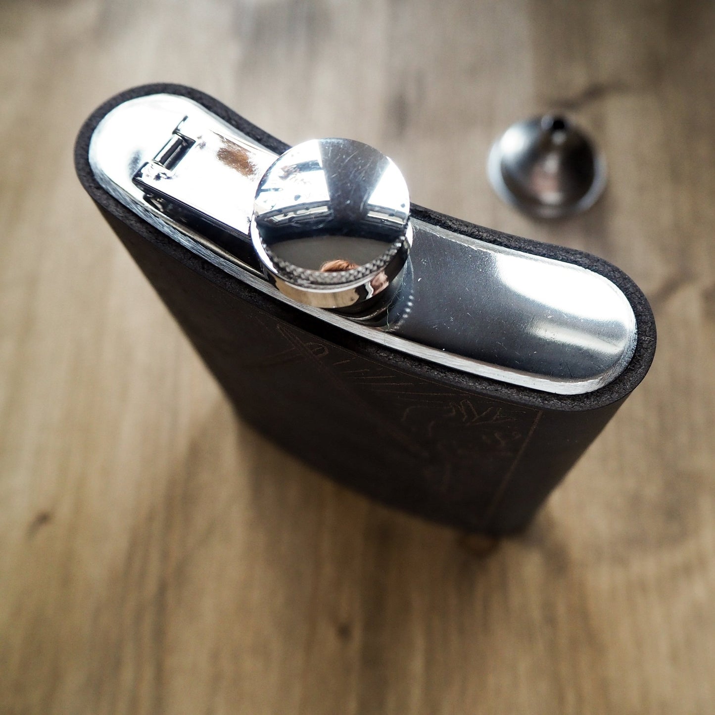 This dungeons and dragons flask is clad onto a stainless steel flask.