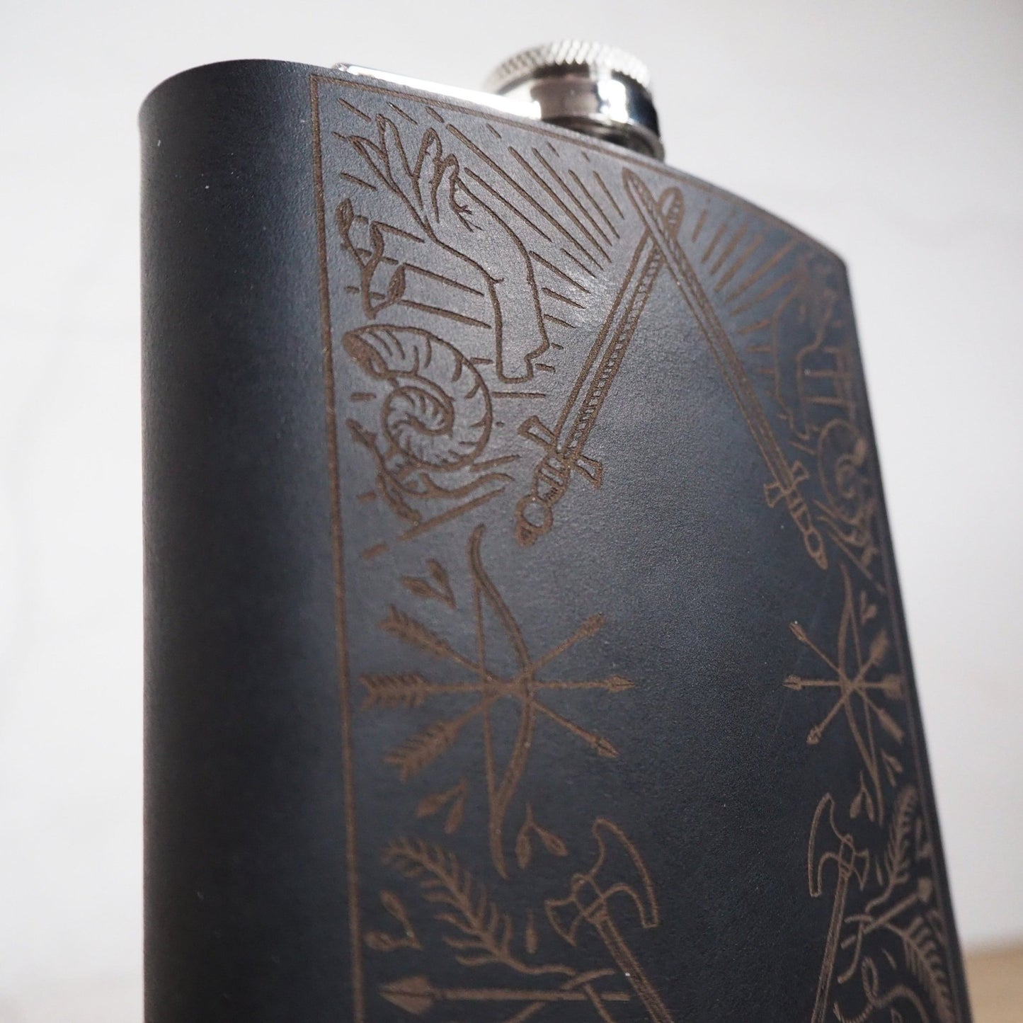 This dungeons and dragons flask is handcrafted from luxurious leather and engraved with the illustration of adventure myriads.