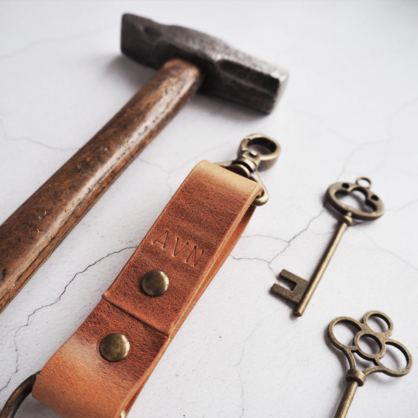 Custom initials engraved onto the Dyrr leather key fob, a luxury leather keyring from HÔRD.