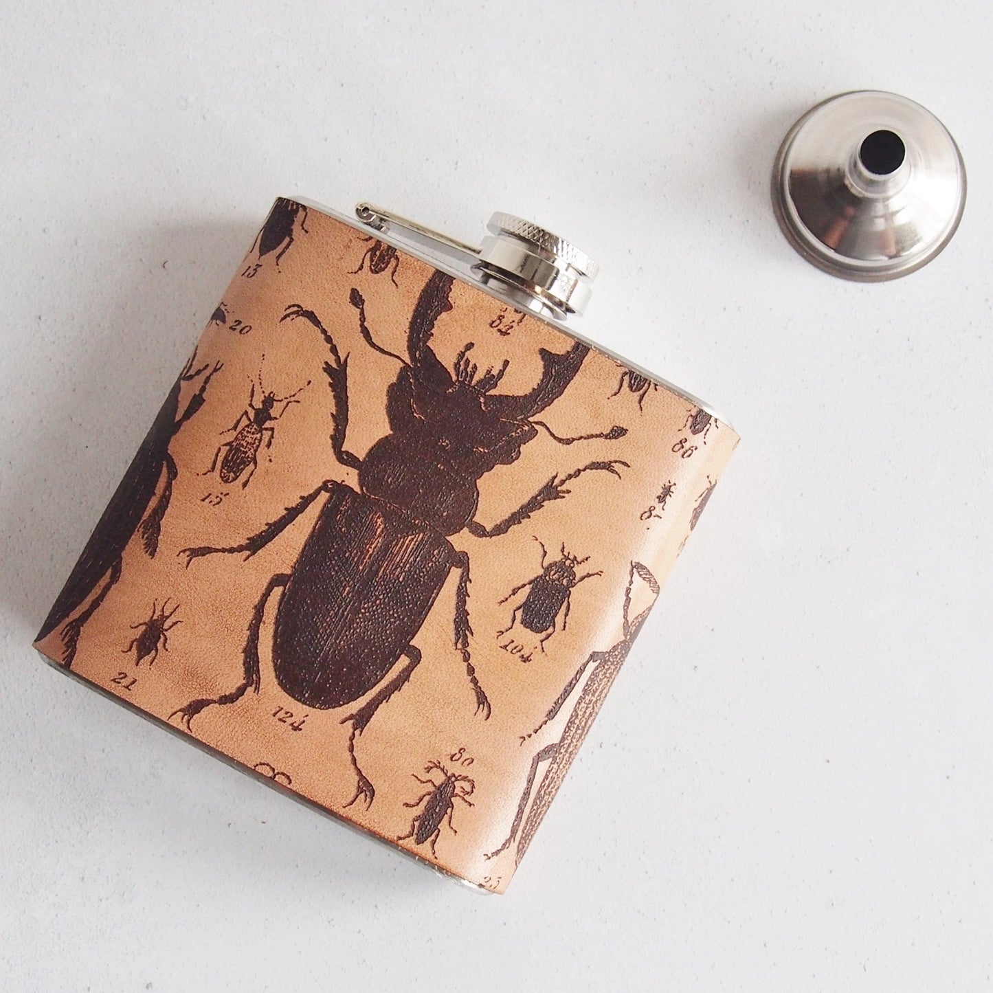 This designer flask comes wrapped in a gift baf with a funnel and care instructions.