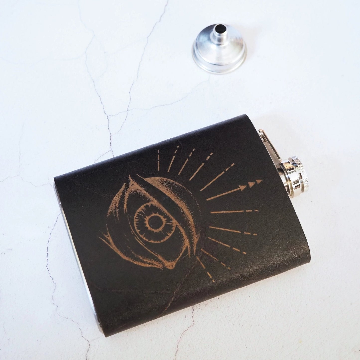 This custom whiskey flask is crafted using luxurious leather and clad onto a stainless steel hip flask.
