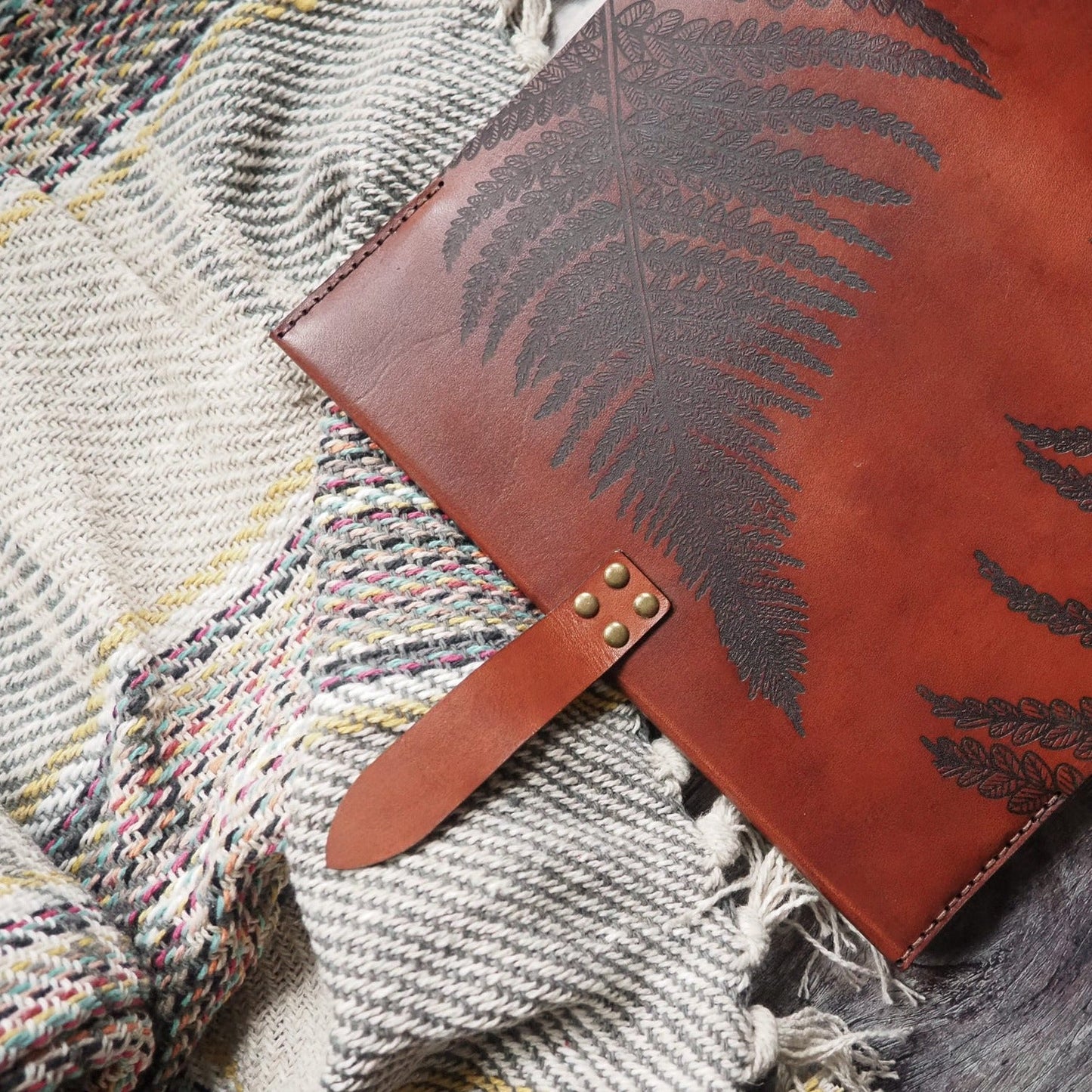 The clasp on the Fern Leaf leather journal cover.