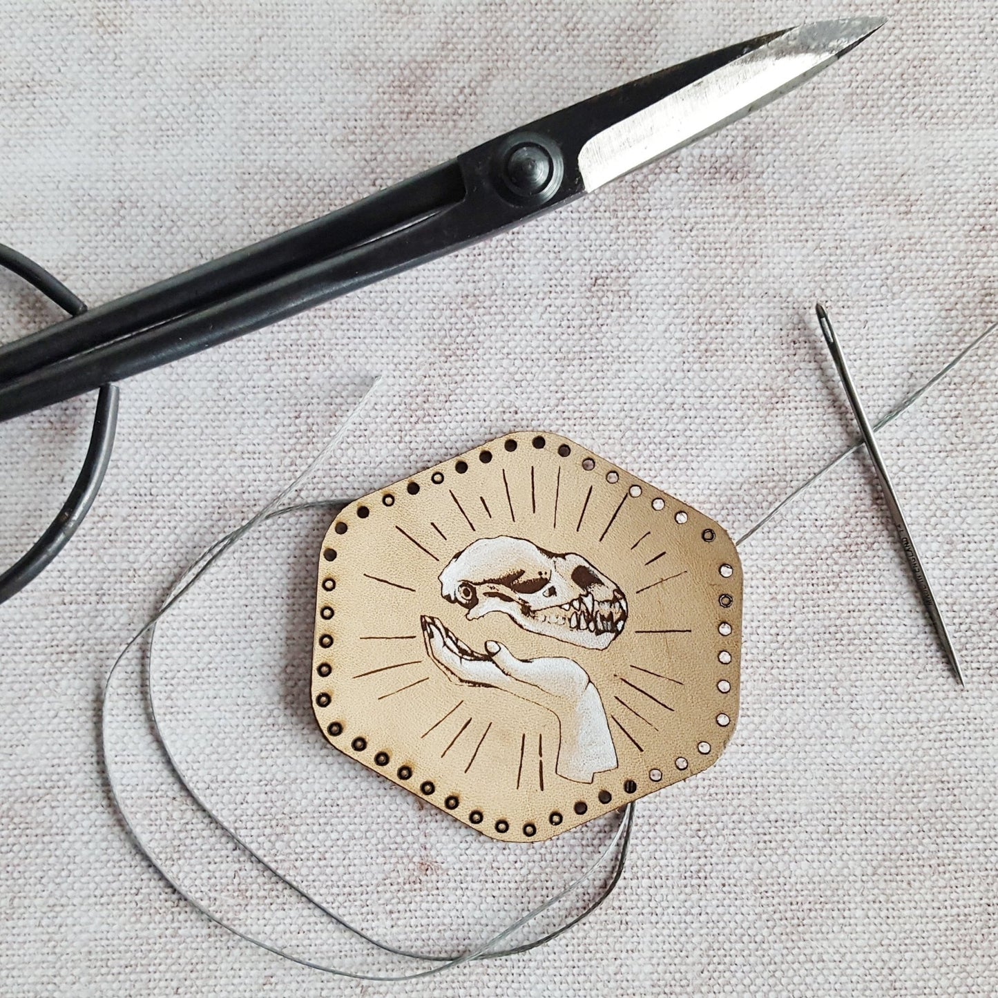 The Levitation Leather Patch by HORD - The Levitation leather patch is illustrated with a small mammal skull and the master magicians hands. Cut from veg tan leather and hand painted, this patch will gain a lovely patina over time - giving a wonderful warm and vintage look, accentuating the grain of the leather. The magixian patch from Hord.