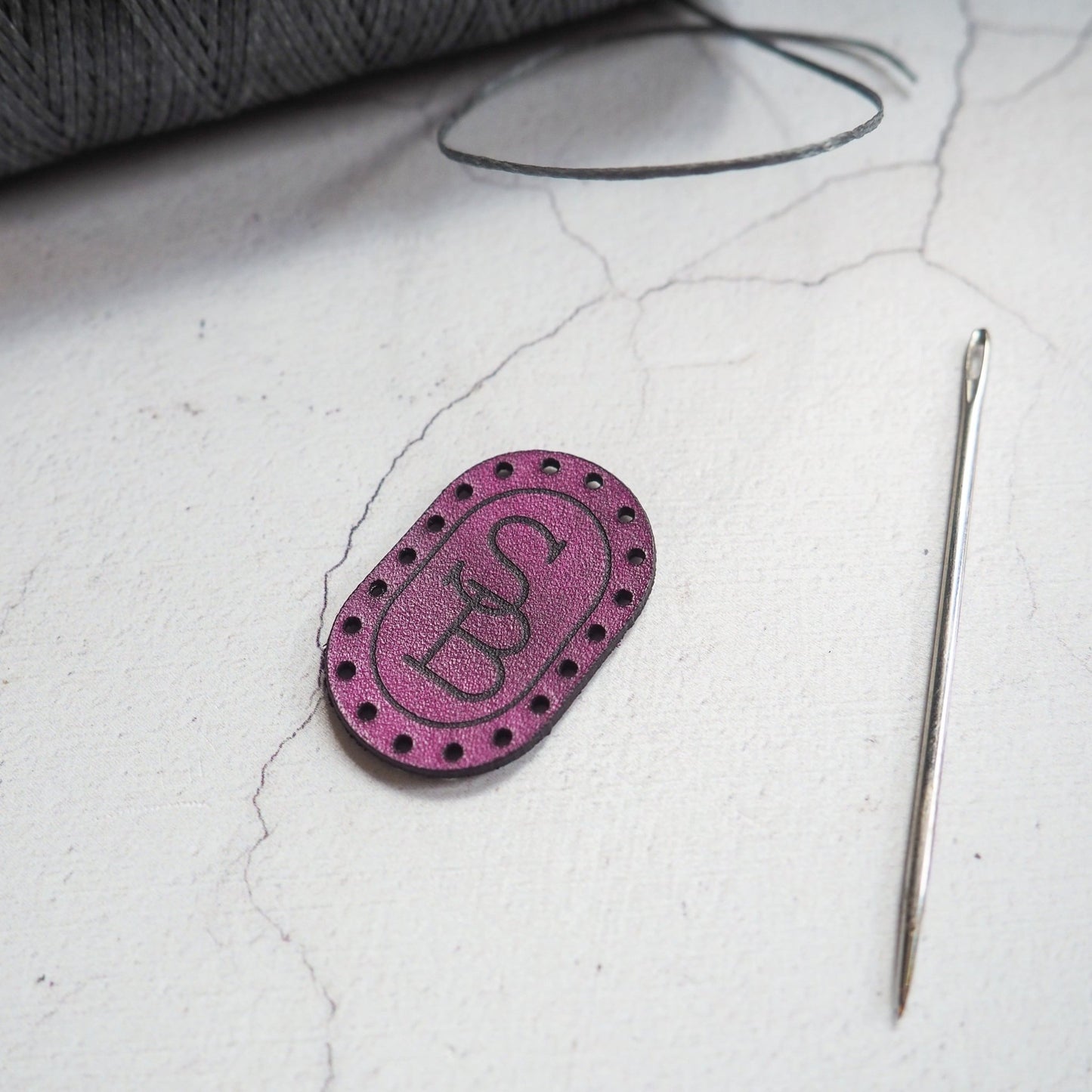 This monogrammed patch from Hord comes with pre-cut stitch holes.