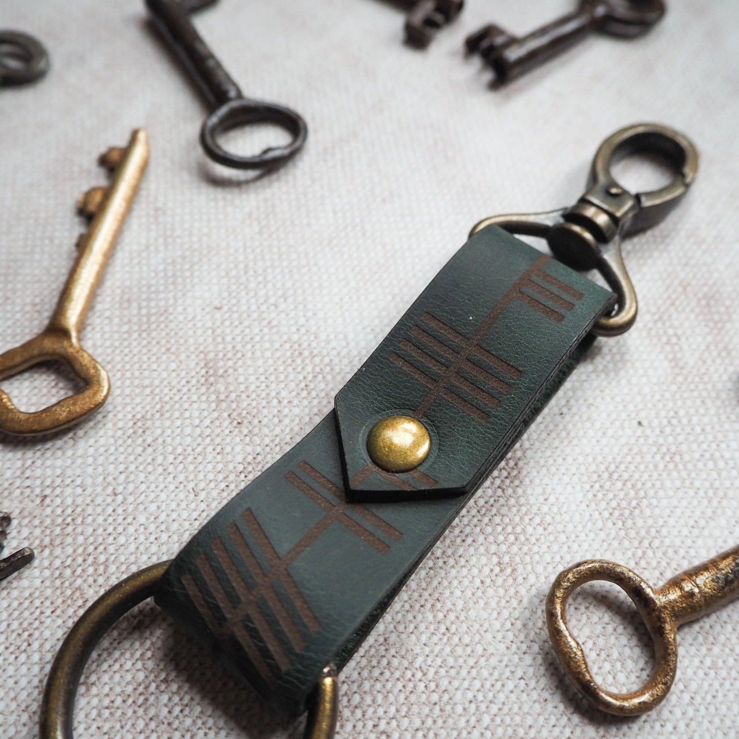Ogham text finely engraved onto the leather keyring.