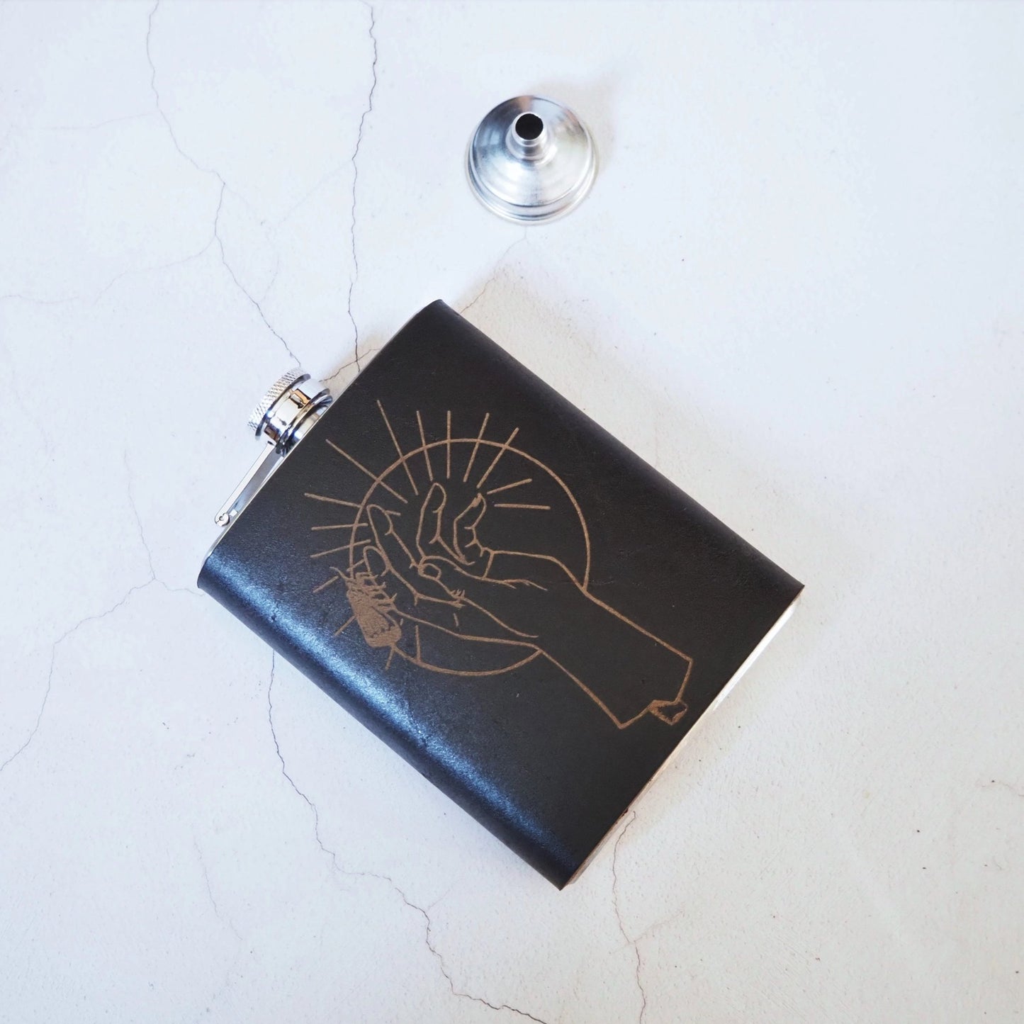 This personalized flask has been handcrafted from luxurious leather and is clad onto a stainless steel hip flask.